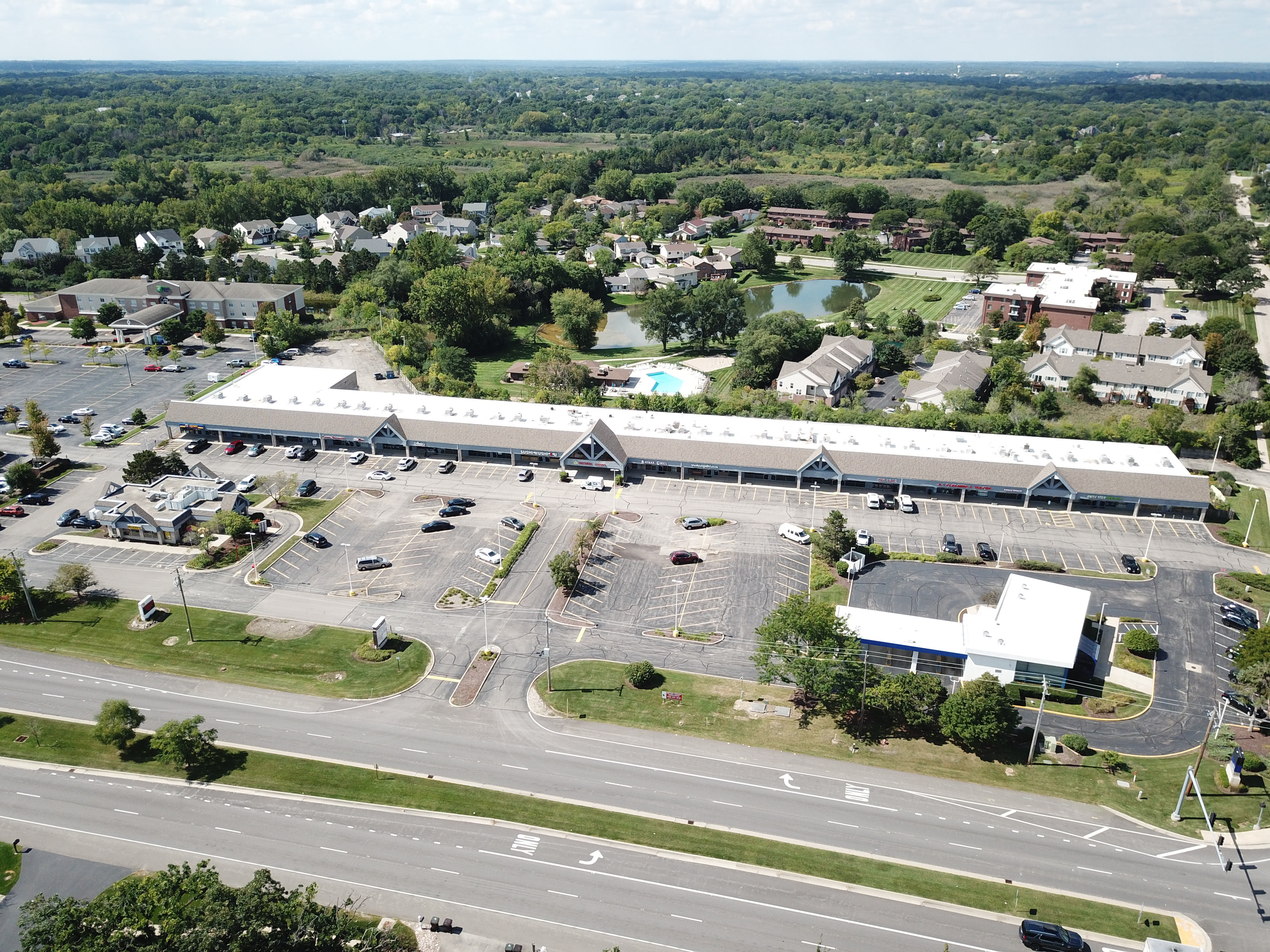 Aerial view of a multi-tenant retail strip center managed by Cambium Commercial